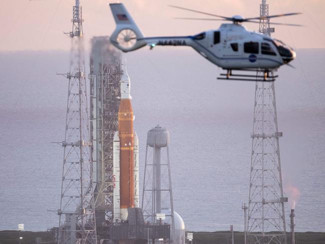 A NASA helicopter flies past the agencyâs Space Launch System (SLS) rocket with the Orion spacecraft aboard atop the mobile launcher at Launch Pad 39B, on August 29, 2022, as the launch countdown progresses at NASAâs Kennedy Space Center in Florida. - NASA called off the test flight on Monday of its largest-ever Moon rocket because of a temperature issue with one of the four giant engines. (Photo by Joel KOWSKY / NASA / AFP) / RESTRICTED TO EDITORIAL USE - MANDATORY CREDIT "AFP PHOTO / Joel Kowsky/ NASA " - NO MARKETING - NO ADVERTISING CAMPAIGNS - DISTRIBUTED AS A SERVICE TO CLIENTS