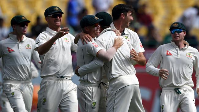 Australia celebrates the run out of India's Cheteshwar Pujara.