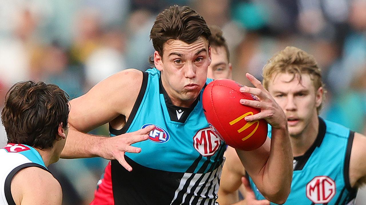 ADELAIDE, AUSTRALIA - JUNE 22: Ollie Lord of the Power and Connor Rozee and Jason Horne-Francis during the 2024 AFL Round 15 match between the Port Adelaide Power and the Brisbane Lions at Adelaide Oval on June 22, 2024 in Adelaide, Australia. (Photo by Sarah Reed/AFL Photos via Getty Images)