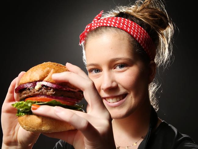 Grill’d employee Morgan Cullen holding a Grill’d burger. Picture: Mark Wilson