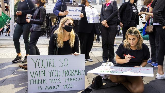 Women are seen writing protest banners at Sydney Town Hall. Picture: Jenny Evans/Getty Images