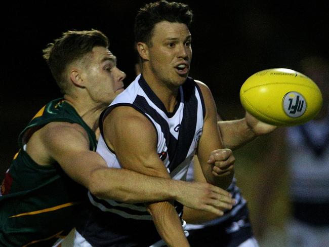 Bundoora’s David Mitchell is put under pressure by Northcote Park’s Tyson Old. Picture: Hamish Blair