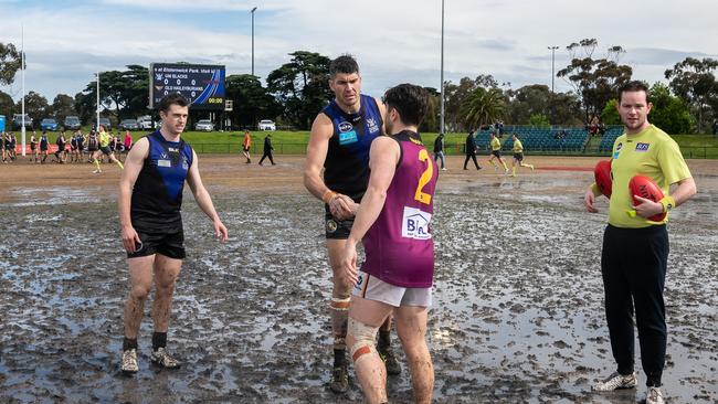 University Blacks and Old Haileybury players shake hands before their VAFA grand final last season. (Picture: VAFA)