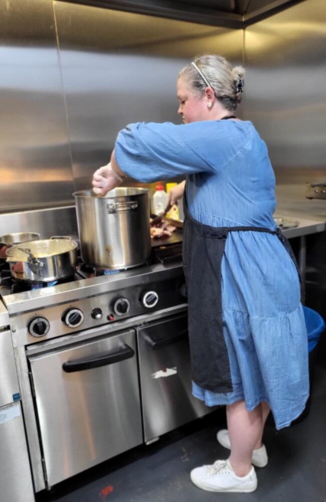 Kenmore Centenary Rugby president Alicia Rossiter in the kitchen cooking free meals for residents.