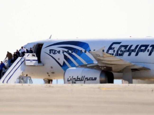 Passengers disembark an Egypt Air Airbus A-320 sitting on the tarmac of Larnaca airport after it was hijacked and diverted to Cyprus. Picture: AFP/GEORGE MICHAEL