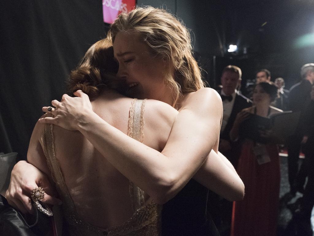 Representatives from PricewaterhouseCoopers, Martha L. Ruiz and Brian Cullinan look on backstage as Brie Larson hugs Emma Stone on winning “Best Actress” during the 89th Annual Academy Awards. Picture: Getty