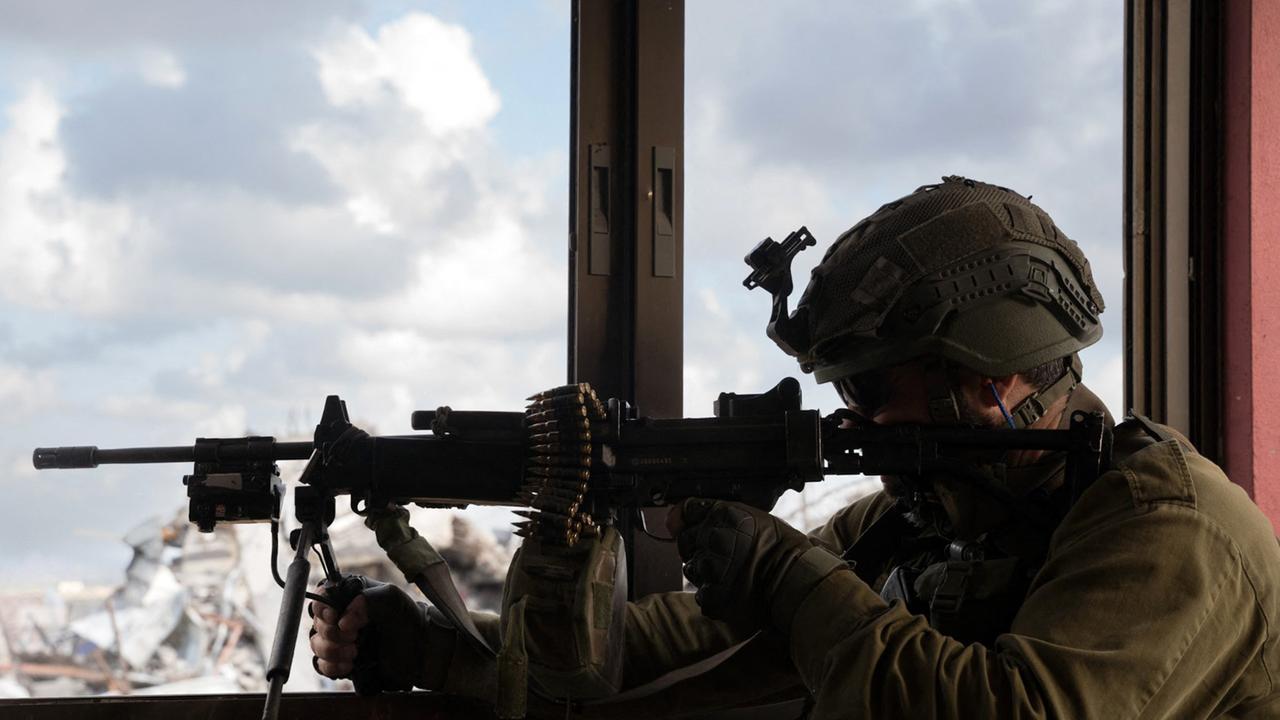 An Israeli soldier aiming a machine gun in a building as part of the activity of the 99th Division in the Zaytoun Area of Gaza. Picture: AFP