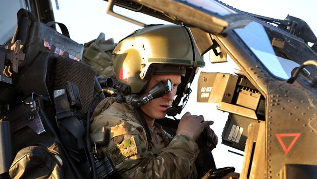 Prince Harry sits in the cockpit of an Apache helicopter at the British controlled flight-line in 2012 in Afghanistan. Picture: Getty Images