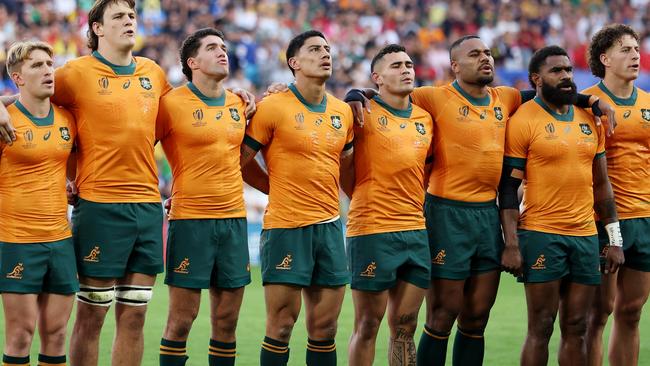 SAINT-ETIENNE, FRANCE - OCTOBER 01: The players of Australia line up during the National Anthems prior to the Rugby World Cup France 2023 match between Australia and Portugal at Stade Geoffroy-Guichard on October 01, 2023 in Saint-Etienne, France. (Photo by Chris Hyde/Getty Images)