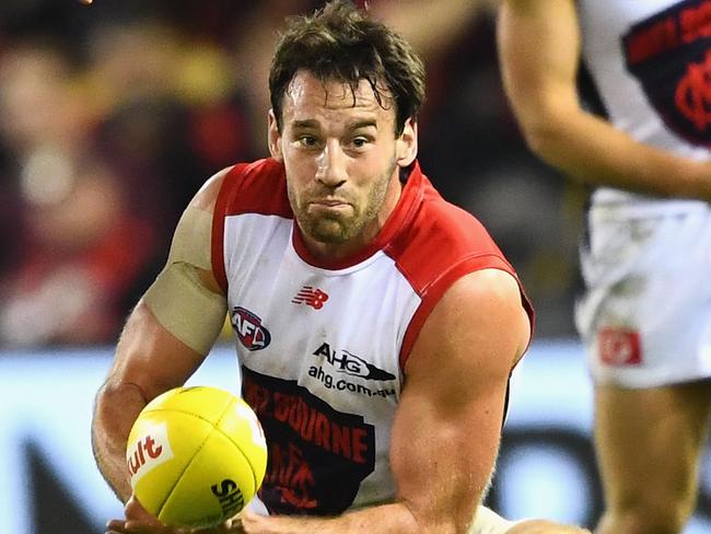 MELBOURNE, AUSTRALIA - APRIL 30:  Cameron Pedersen of the Demons handballs whilst being tackled during the round six AFL match between the Essendon Bombers and the Melbourne Demons at Etihad Stadium on April 30, 2017 in Melbourne, Australia.  (Photo by Quinn Rooney/Getty Images)