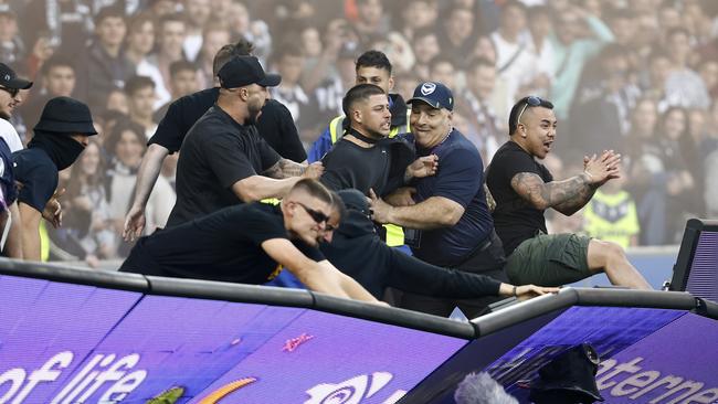 Spectators storm the pitch during the Melbourne derby.