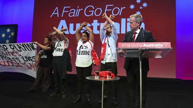 Anti-Adani protesters get on stage as Australian Opposition leader Bill Shorten speaks during the Labor Party National Conference in Adelaide last year. Picture: AAP/Lukas Coch