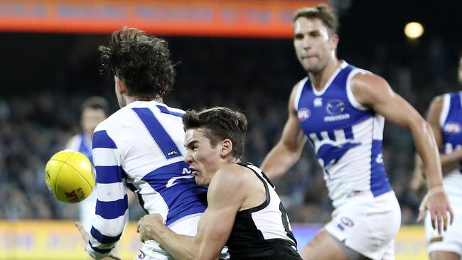 Connor Rozee tackles North Melbourne’s Jasper Pittard on Friday night. Picture SARAH REED