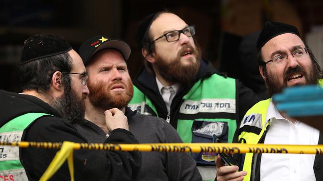 JERSEY CITY, NJ - DECEMBER 11: Recovery and clean up crews work the scene in the aftermath of a mass shooting at the JC Kosher Supermarket on December 11, 2019 in Jersey City, New Jersey. Six people, including a Jersey City police officer and three civilians were killed in a deadly, hours-long gun battle between two armed suspects and police on Tuesday in a standoff and shootout in a Jewish market that appears to have been targeted, according to Jersey City Mayor Steven Fulop.   Rick Loomis/Getty Images/AFP