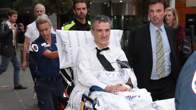 Terry McMaster leaves the banking royal commission hearings in the care of paramedics in 2018. Picture: AAP