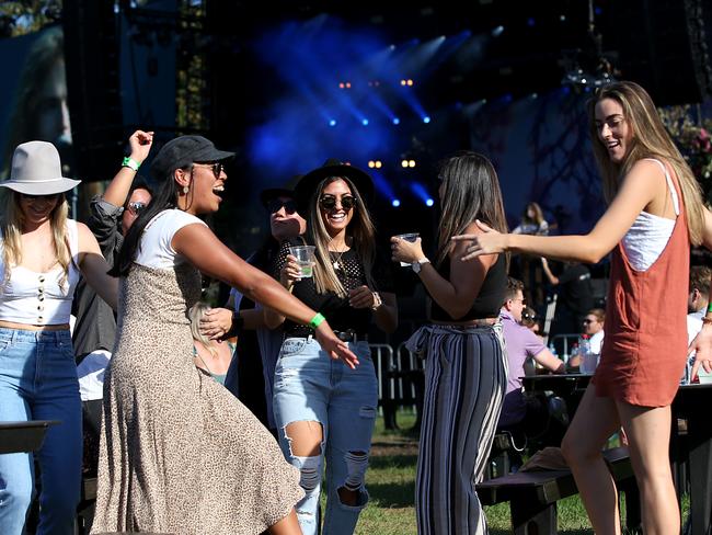 The music festival Summer in the Domain has been given an exemption to start dancing a day earlier as revellers take the directive (L-R) Georgie Exton, Angelica Angeles, Jolene Haddad, Clare maroon and Jessi Sapsed cut loose. Dancing restrictions will be lifted in NSW from Monday. Jane Dempster/The Australian.