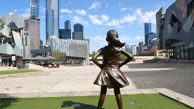 A replica of New York’s Fearless Girl looks over a completely deserted Federation Square in Melbourne’s CBD. Picture: Josie Hayden