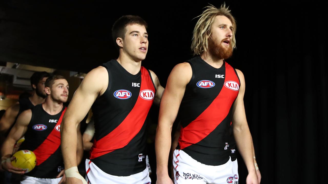 Essendon skipper Dyson Heppell leads the Bombers out on Saturday night.