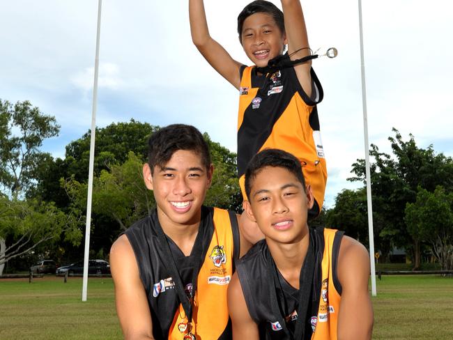 Nightcliff’s Mu brothers pictured with plenty of winning silverware after junior grand-final day in the 2013-14 NTFL season. Ryan, 15 at the time, Kieran, 11, and Nathan, 13, made space in the family trophy cabinet after all three won premierships. Ryan and Kieran also won best-and-fairest awards. Picture: JUSTIN SANSON