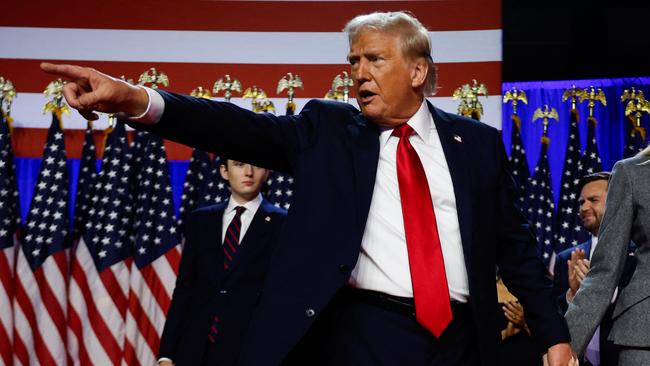 WEST PALM BEACH, FLORIDA - NOVEMBER 06: Republican presidential nominee, former U.S. President Donald Trump points to supporters with former first lady Melania Trump during an election night event at the Palm Beach Convention Center on November 06, 2024 in West Palm Beach, Florida. Americans cast their ballots today in the presidential race between Republican nominee former President Donald Trump and Vice President Kamala Harris, as well as multiple state elections that will determine the balance of power in Congress.   Chip Somodevilla/Getty Images/AFP (Photo by CHIP SOMODEVILLA / GETTY IMAGES NORTH AMERICA / Getty Images via AFP)