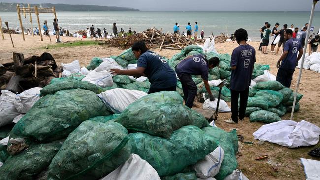 Participants and volunteers remove plastic waste and other garbage washed ashore at a beach in Kedonganan Badung regency, Indonesia's Bali island. Picture: AFP