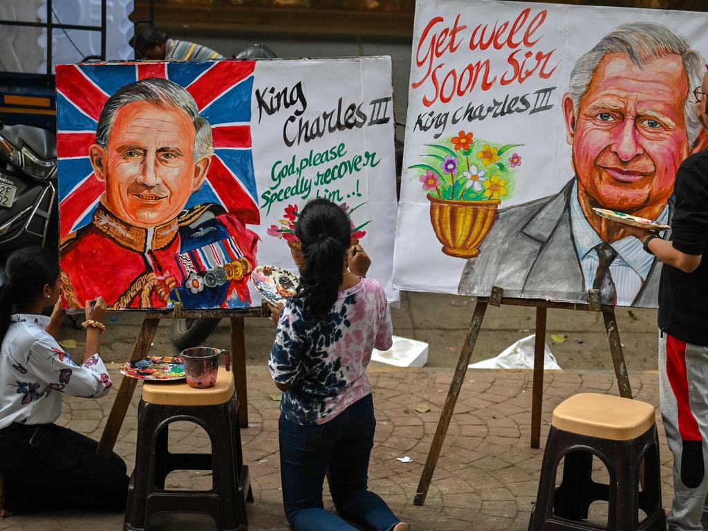 An artist and students give finishing touches to paintings of King Charles in Mumbai. Picture: AFP