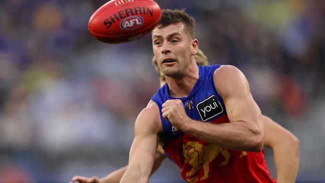 PERTH, AUSTRALIA - JULY 14: Josh Dunkley of the Lions handballs during the round 18 AFL match between West Coast Eagles and Brisbane Lions at Optus Stadium, on July 14, 2024, in Perth, Australia. (Photo by Paul Kane/Getty Images)