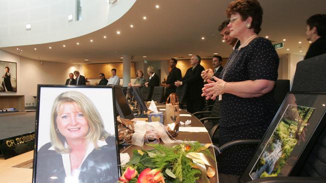 A picture and flowers left for Sue Robbins on her desk in the council chambers following her death. Picture: Glenn Hampson.