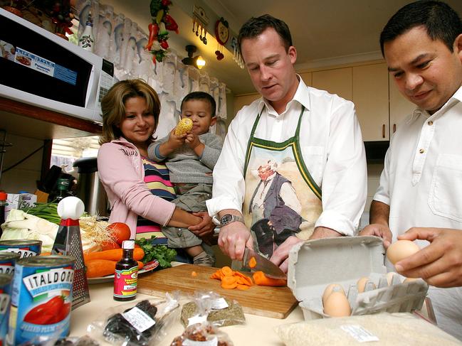 El Salvadorean themed fundraising dinner preview, from left Vanessa Ceren with baby Jeshua, two and a half, Opposition Leader Will Hodgman and Nestor Rodriguez preparing the food for the dinner