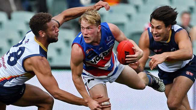 Pressure ... Central District’s Travis Chiller is hunted by Crows Cam Ellis-Yolmen and Troy Menzel. Picture: Tom Huntley