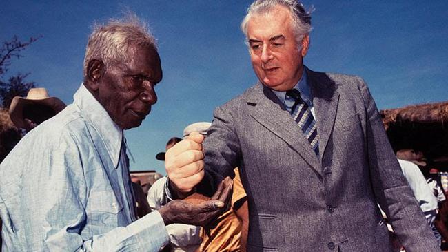 Gough Whitlam pours soil into the hands of Vincent Lingiari in 1975. Picture: Merv Bishopl