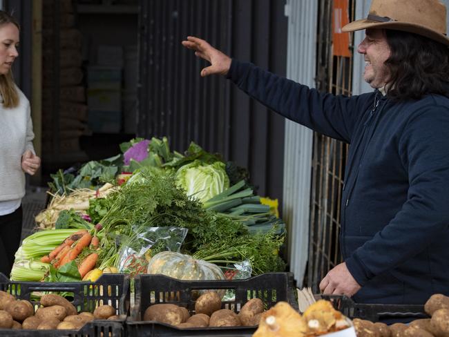 Vegetable grower Sandor Istella serving customers at Bendigo Community Farmers' Market. Picture: Zoe Phillips