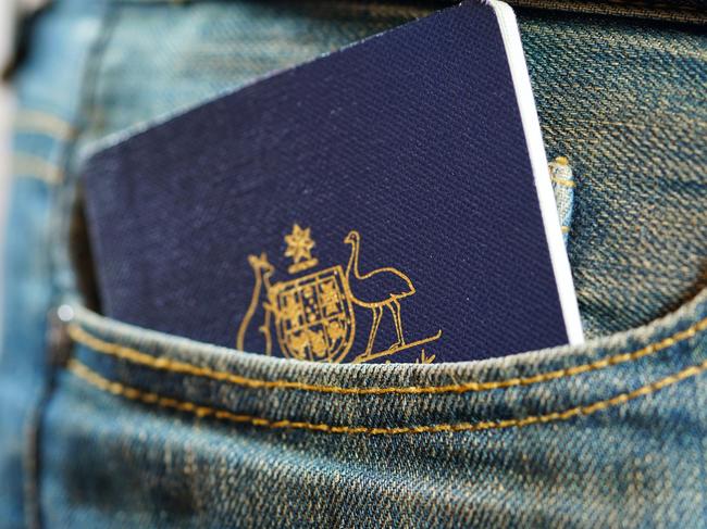 ESCAPE, TRAVEL WISDOM, passport careAustralian passport in mans jeans pocket, close up.