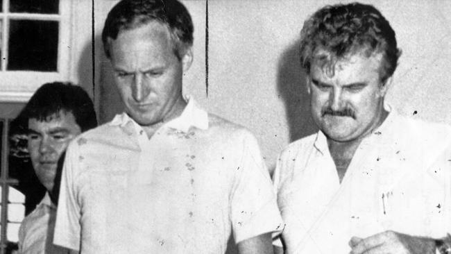 West, centre, is escorted by police into the Cairns court for bail application hearing in February, 1985.