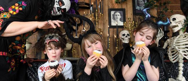 Sevdah 7, Nicholas 6, and Lindsay 9, tuck into a Halloween tea party at Hirestyle. Picture: Penny Stephens