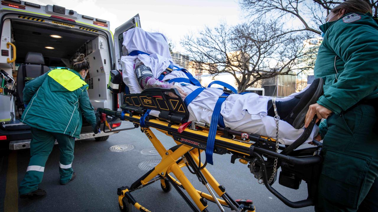 Raelene Polymiadis is chained to her ambulance stretcher as she’s wheeled out of court after collapsing. Picture: NCA NewsWIRE / Emma Brasier