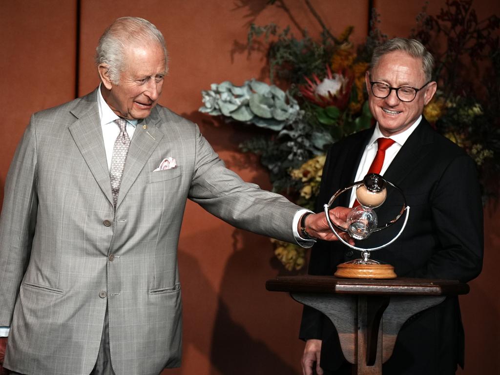 president of the Legislative Council, Ben Franklin (right), watches as King Charles III turns an hourglass he is presenting as a gift to mark the Bicentenary of the New South Wales Legislative Council. Picture: Aaron Chown/Pool via Getty Images