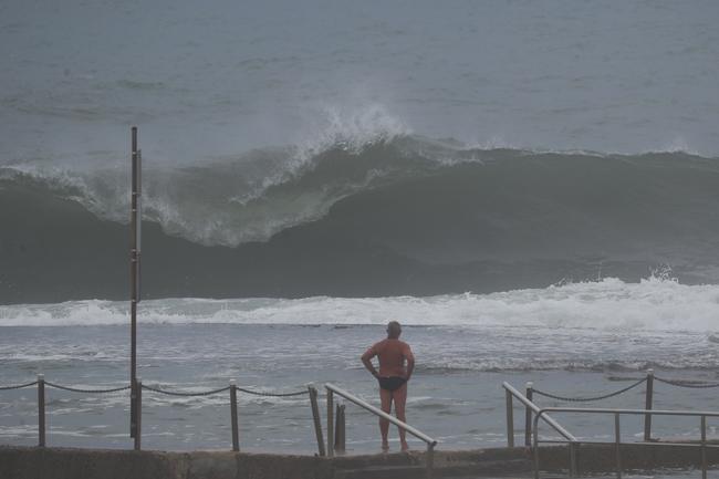 People braving the big surf on the northern beaches. Picture: John Grainger