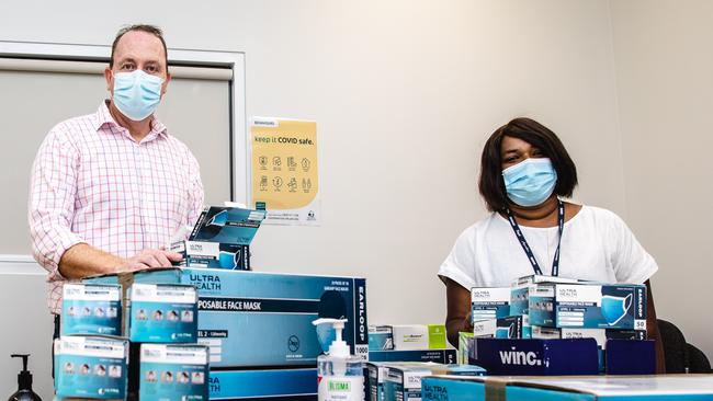 Jason Szczerbanik and Vidhya Chelliah assembling back to school Covid packs. Picture: Linda Higginson