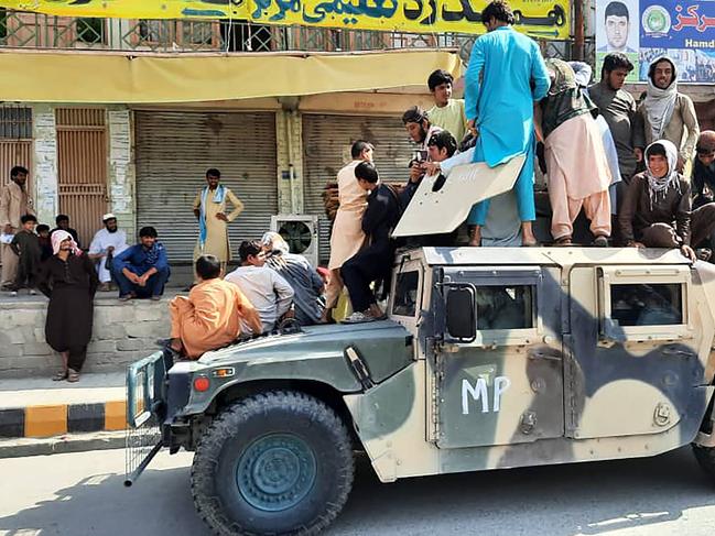 Taliban fighters sit on an Afghan National Army (ANA) humvee vehicle after seizing Langham province on August 15. Picture: AFP