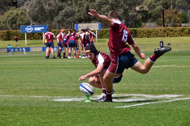 Isaac Fidock helps Dylan Terblanche kick for goal. Action from the Under-16s clash between the ACT Brumbies and Queensland Reds. Picture courtesy of @jayziephotography