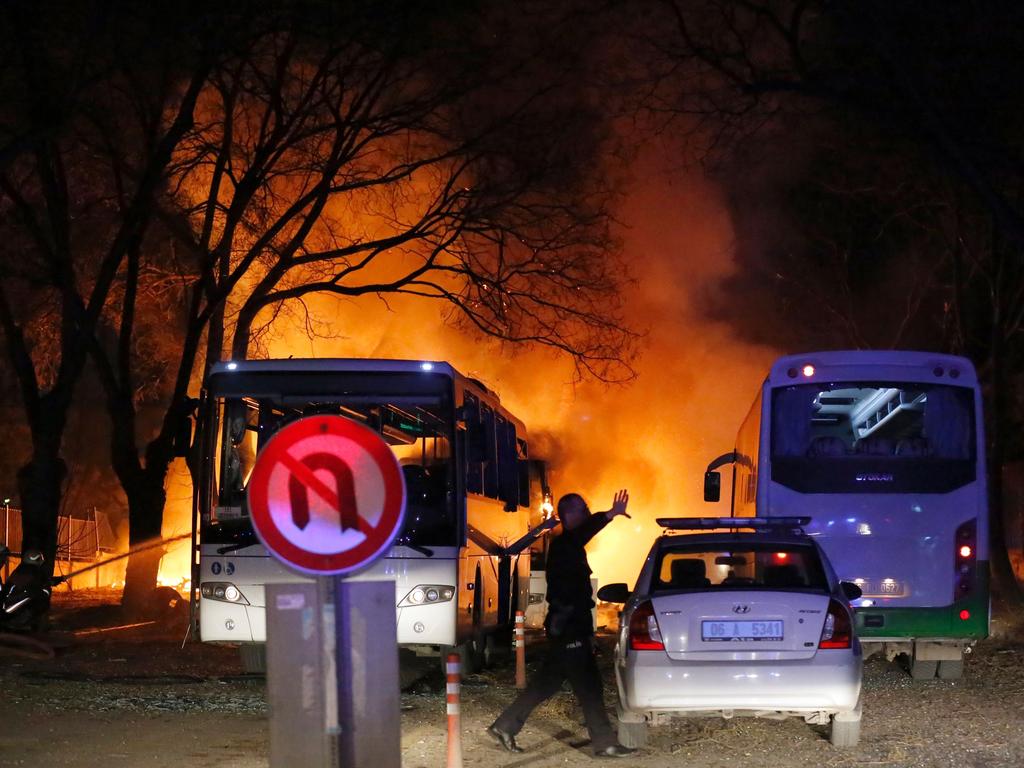 A police officer gestures as he walks at the site of an explosion while firefighters try to extinguish flames after an attack targeted a convoy of military service vehicles in Ankara on February 17, 2016. At least 18 people were killed and 45 wounded by a car bomb targeting the military in the heart of the Turkish capital Ankara on February 17, the city’s governor said. The bloodshed came on the heels of a string of attacks in Turkey, blamed on jihadists but also on Kurdish rebels. The bomb aimed at a convoy of military service vehicles, Ankara governor Mehmet Kiliclar said, quoted by the CNN-Turk and NTV channels. Picture: AFP