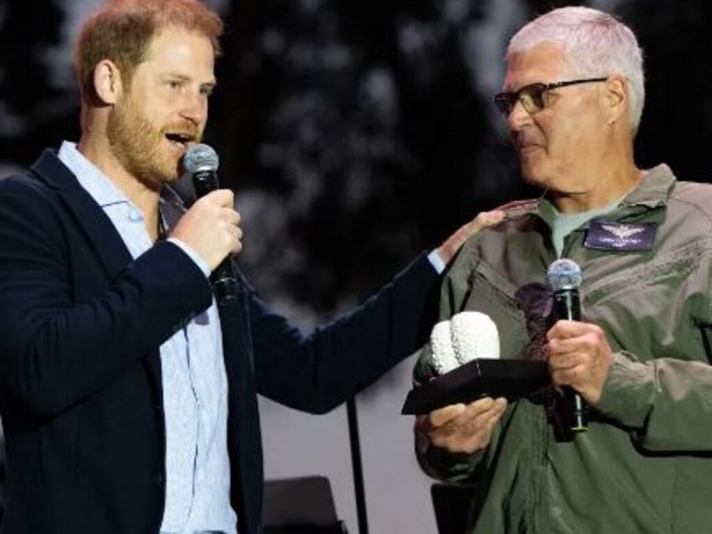 Prince Harry presenting an award to Santa Barbara County Sheriff’s Office helicopter pilot Loren Courtney. Picture: Getty Images