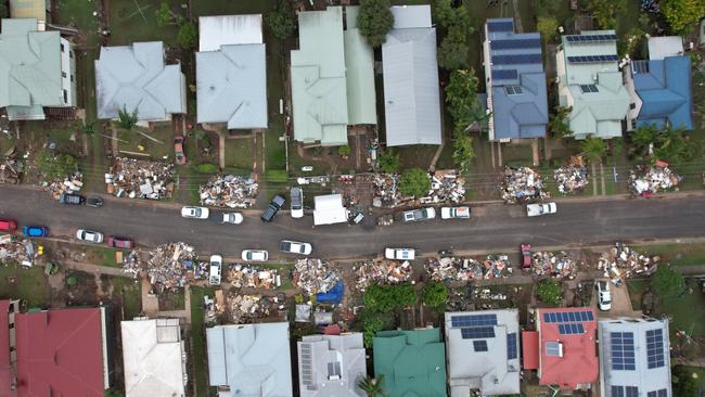 Masses of debris outside Lismore homes on March 10 last year. Picture: NCA NewsWire/Danielle Smith