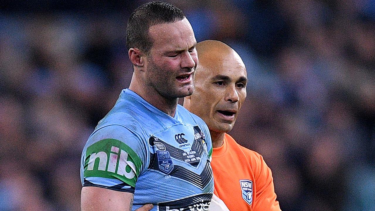 Boyd Cordner of the Blues is assisted from the field.