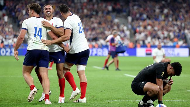 PARIS, FRANCE - SEPTEMBER 08: Melvyn Jaminet, Damian Penaud and Paul Boudehent of France celebrate their side's second try as Richie Mo'unga of New Zealand looks dejected during the Rugby World Cup France 2023 Pool A match between France and New Zealand at Stade de France on September 08, 2023 in Paris, France. (Photo by Warren Little/Getty Images)