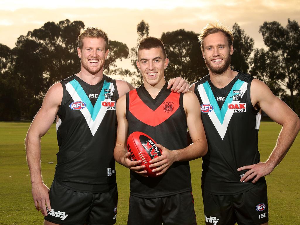 Rostrevor College potential Under 18 State Squad member; footballer Luke Valente, 18yrs, with AFL Port Power players Tom Jonas and Jack Hombsch at the Rostrevor College oval. Picture: DYLAN COKER