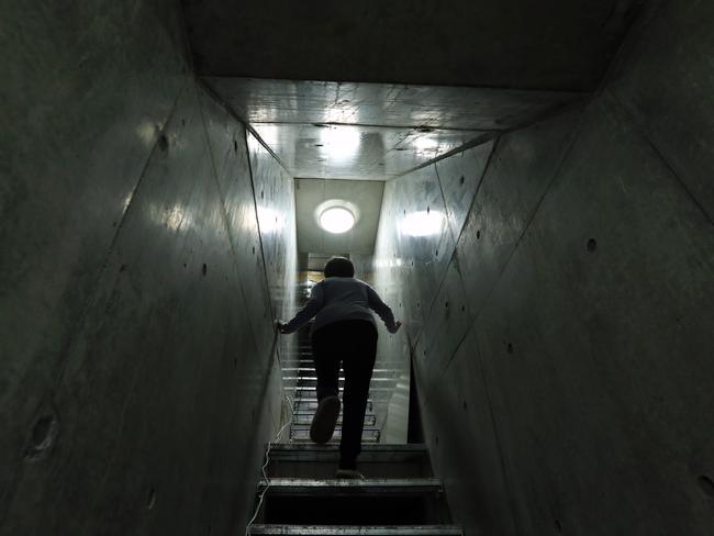 A woman climbs from her nuclear shelter in Hara, Nagano, Japan. Some people are preparing for the worst case scenario as tensions rise between North Korea and United States. Picture: Buddhika Weerasinghe / Getty