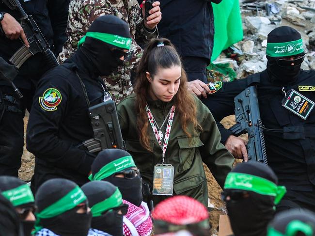 Hamas militants escort Israeli hostage Agam Berger before handing her over to a Red Cross team in Jabalia as part of their third hostage-prisoner exchange. Picture: Omar Al-Qattaa/ AFP