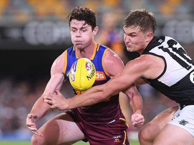 Lachie Neale of the Lions (left) competes with Ollie Wines of the Power during the Round 3 AFL match between the Brisbane Lions and Port Adelaide Power at the Gabba in Brisbane, Saturday, April 6, 2019. (AAP Image/Dave Hunt) NO ARCHIVING, EDITORIAL USE ONLY